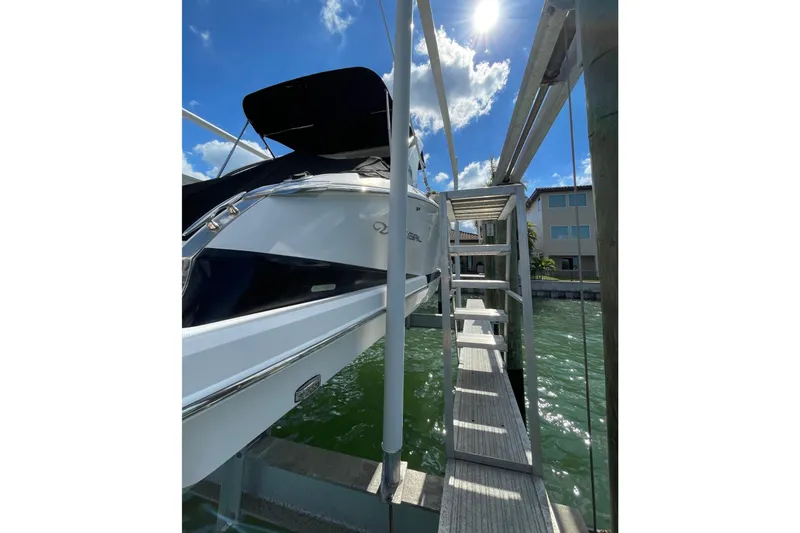 Slide: The Image of 2018 Regal 29 OBX boat docked under sunny skies. - 4