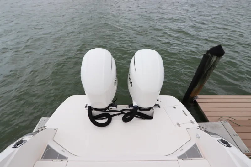 Slide: The Image of 2018 Regal 29 OBX boat with twin outboard engines docked on water. - 9