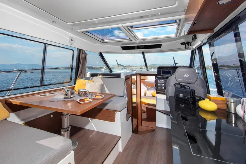 Slide: The Image of Interior of 2026 Jeanneau NC 1095 Coupe, featuring modern seating and panoramic windows. - 4