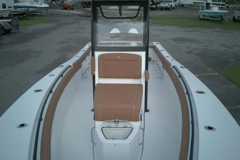 Slide: The Image of 2026 Sea Hunt Gamefish 27 Coffin Box boat interior with brown seating and white deck. - 12