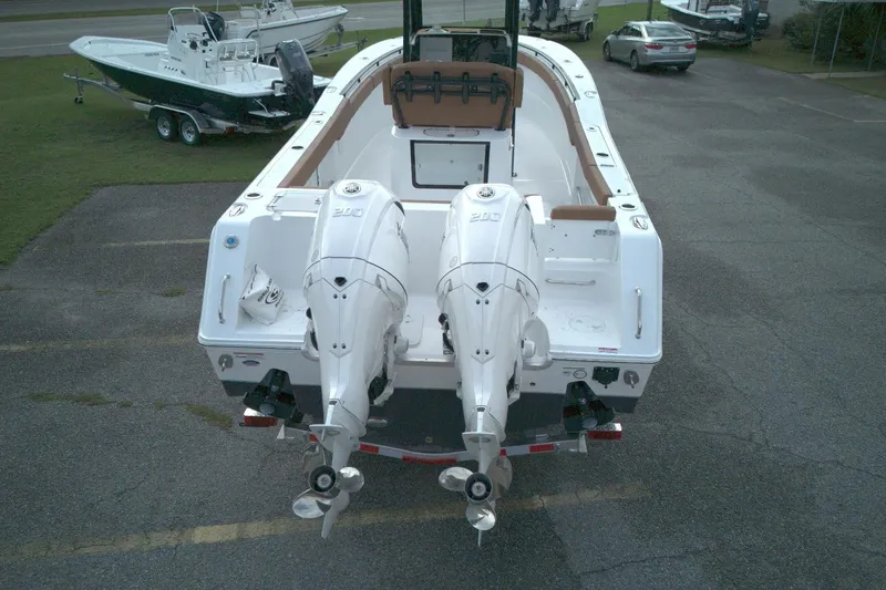 Slide: The Image of 2026 Sea Hunt Gamefish 27 Coffin Box boat with dual outboard engines, parked on a lot. - 2