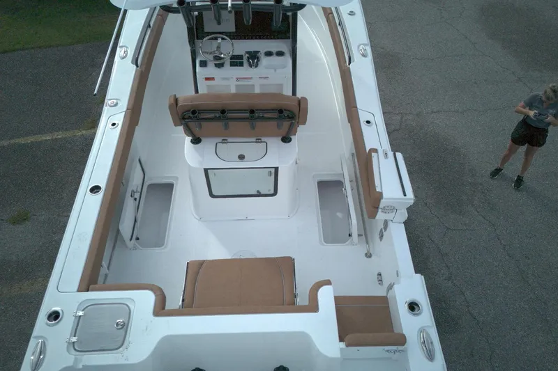 Slide: The Image of 2026 Sea Hunt Gamefish 27 Coffin Box boat interior, aerial view, with person nearby. - 4