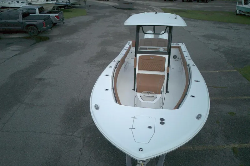 Slide: The Image of 2026 Sea Hunt Gamefish 27 Coffin Box boat, aerial view, parked on asphalt. - 9