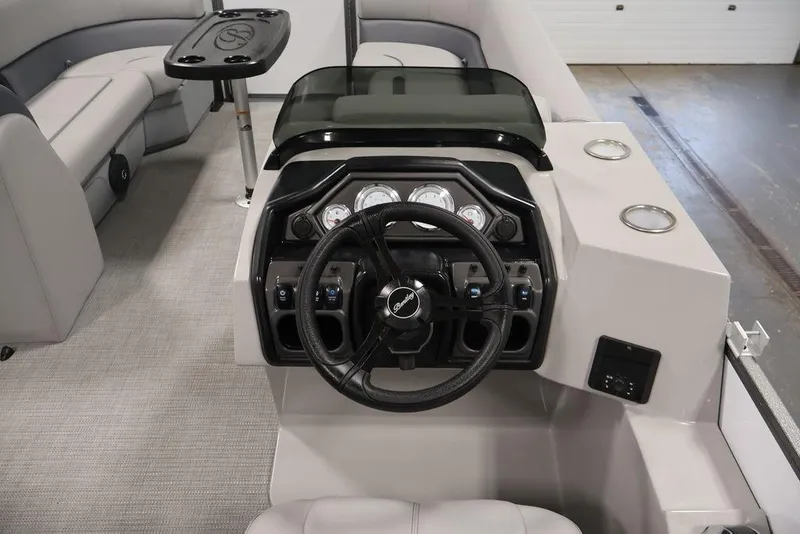 Slide: The Image of Interior view of 2026 Bentley Pontoons 240 Swingback, featuring steering console and seating area. - 16