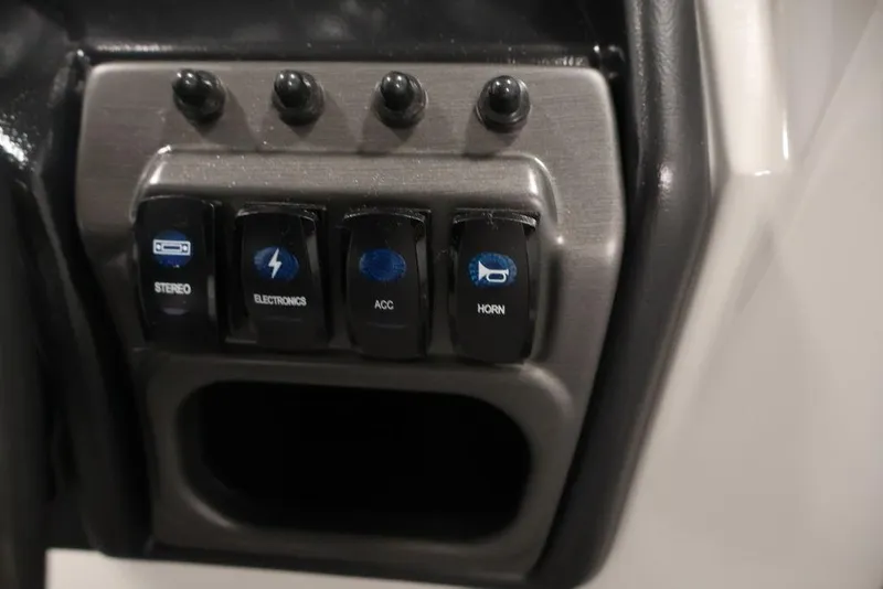 Slide: The Image of Control panel of 2026 Bentley Pontoons 240 Swingback with stereo, electronics, and horn switches. - 21