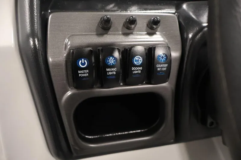 Slide: The Image of Control panel of 2026 Bentley Pontoons 240 Swingback with labeled switches for lights and power. - 23