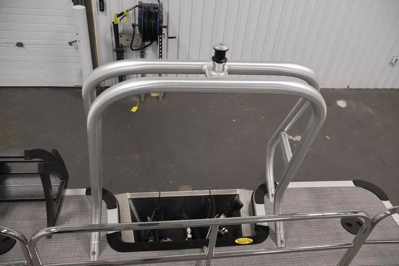 Slide: The Image of 2026 Bentley Pontoons 240 Swingback with aluminum railing and deck details in a workshop. - 25