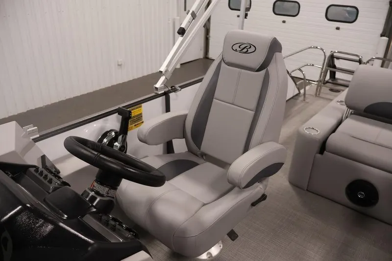 Slide: The Image of 2026 Bentley Pontoons 240 Swingback interior with captain's chair and steering wheel. - 27