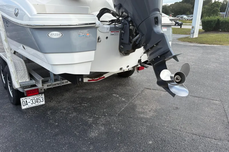Slide: The Image of 2022 NauticStar 203 DC boat on trailer, featuring outboard motor and North Carolina license plate. - 12