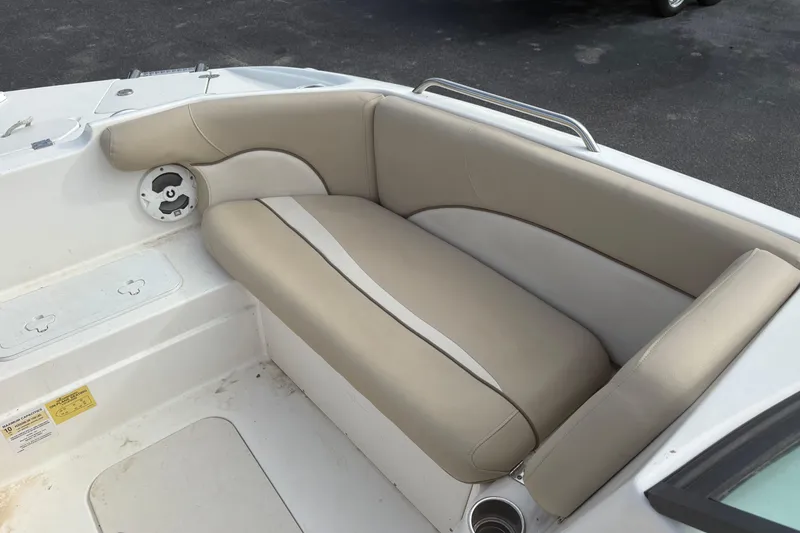 Slide: The Image of 2022 NauticStar 203 DC boat interior with beige seating and cup holder. - 14