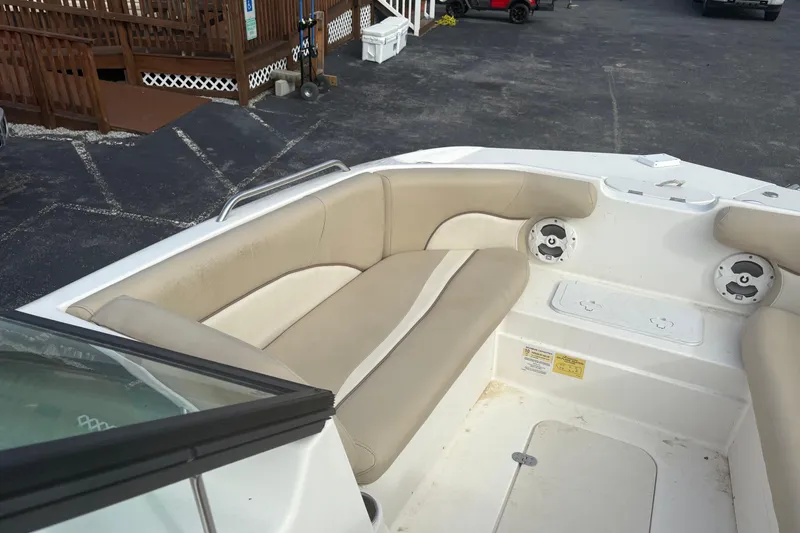 Slide: The Image of 2022 NauticStar 203 DC boat interior with beige seating and speakers. - 15