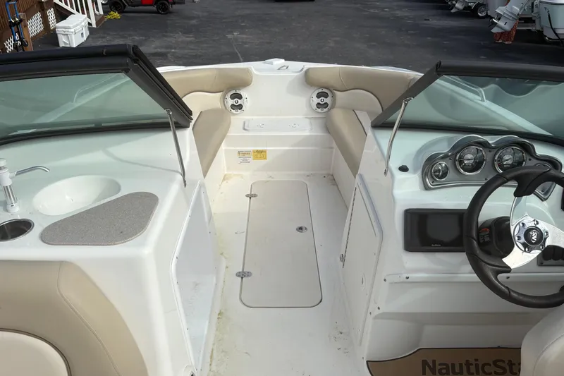 Slide: The Image of 2022 NauticStar 203 DC boat interior with steering wheel, seating, and dashboard controls. - 19