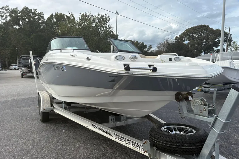 Slide: The Image of 2022 NauticStar 203 DC boat on trailer in parking lot, overcast sky. - 8