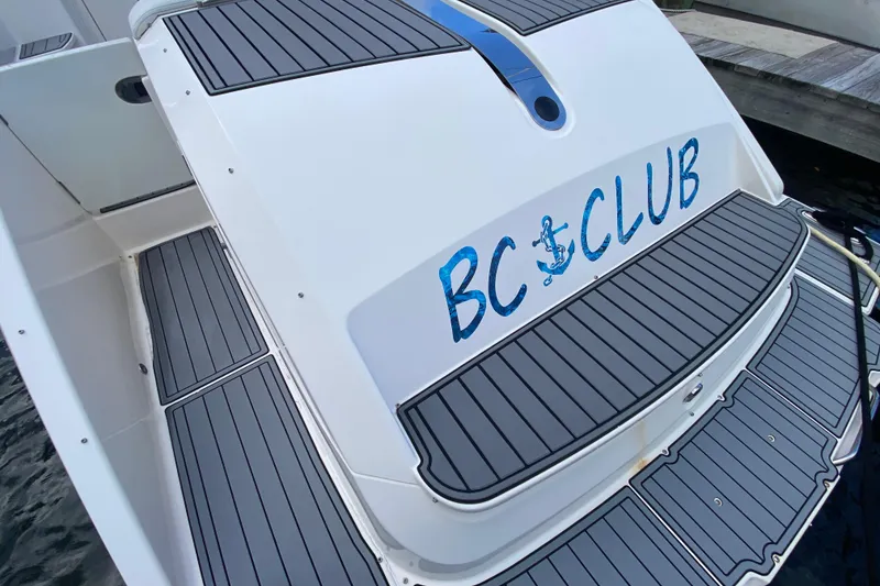 Slide: The Image of 2014 Pursuit SC 365i Sport Coupe docked, showcasing sleek design and spacious deck. - 20