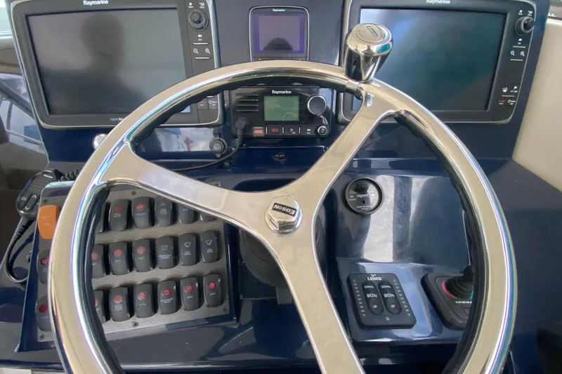 Slide: The Image of 2014 Pursuit SC 365i Sport Coupe helm with dual Raymarine displays and steering wheel. - 28