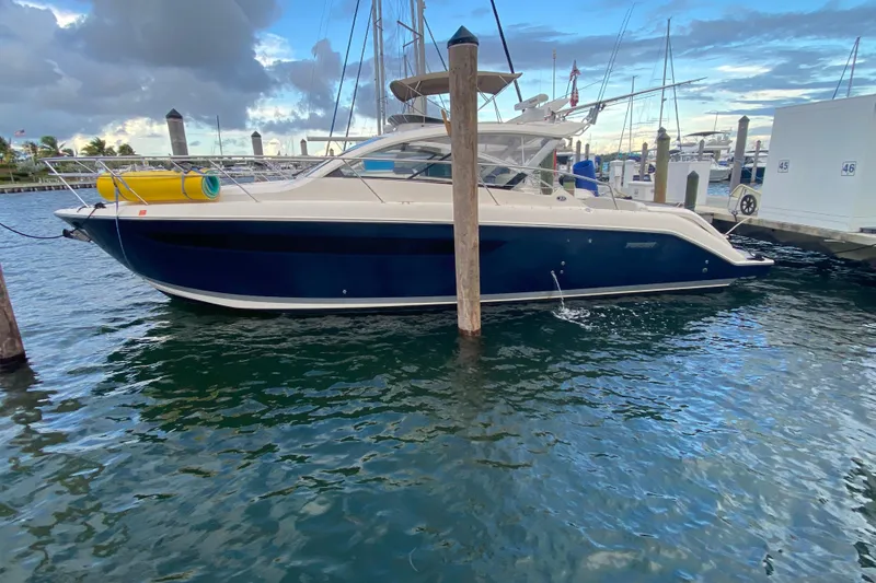 Slide: The Image of 2014 Pursuit SC 365i Sport Coupe docked, aerial view, with yellow floatation device. - 4