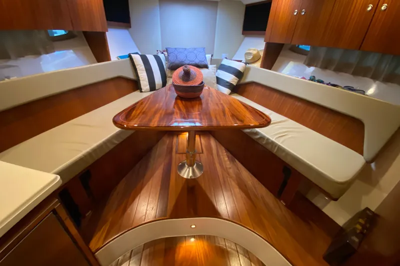 Slide: The Image of Luxurious interior of 2014 Pursuit SC 365i Sport Coupe with wooden table and modern amenities. - 42