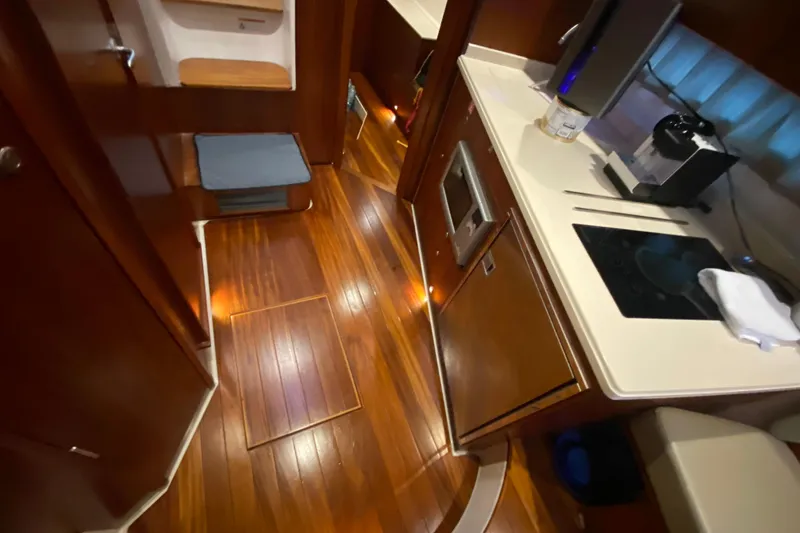 Slide: The Image of Interior view of 2014 Pursuit SC 365i Sport Coupe with wooden cabinetry and ceiling lights. - 45