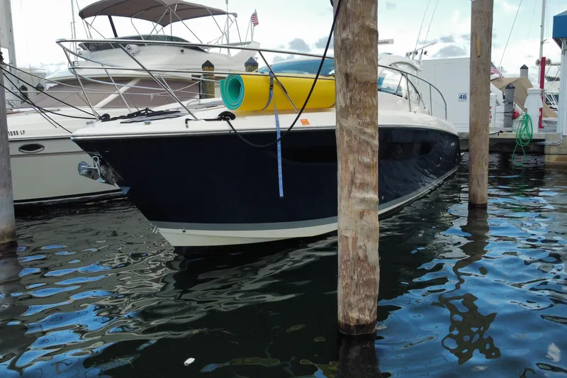 Slide: The Image of 2014 Pursuit SC 365i Sport Coupe docked at marina, featuring sleek design and vibrant blue hull. - 8