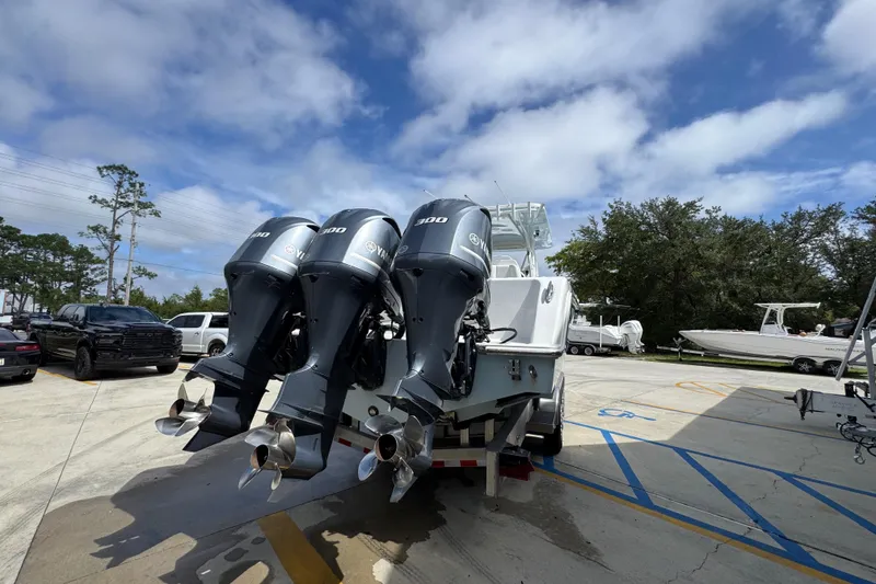 Slide: The Image of 2019 Invincible 39 Open Fisherman with triple outboard engines in a parking lot. - 11