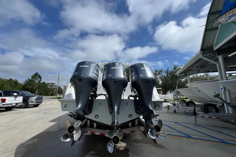 Slide: The Image of 2019 Invincible 39 Open Fisherman with triple 300 horsepower engines, parked outdoors. - 12