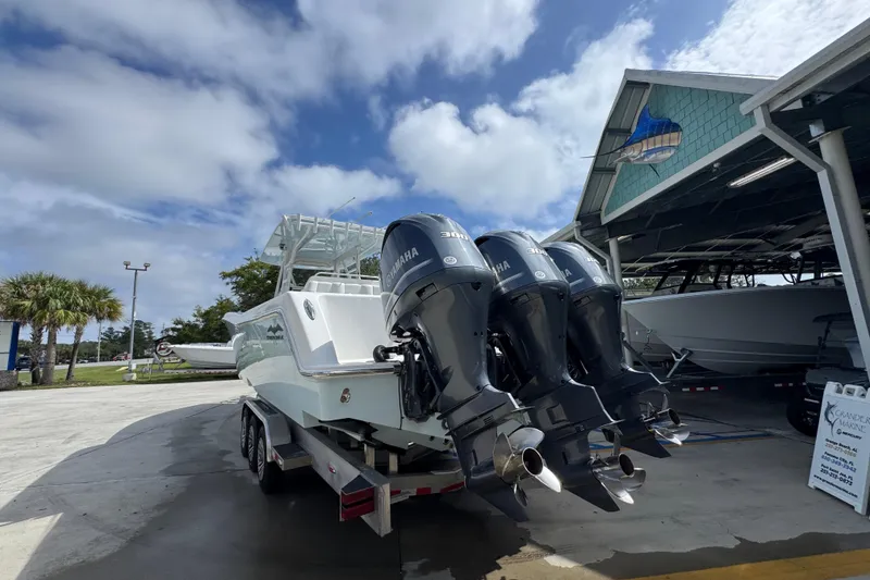 Slide: The Image of 2019 Invincible 39 Open Fisherman with triple Yamaha engines at a marina. - 13