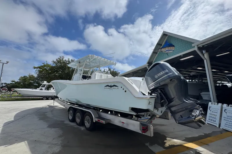 Slide: The Image of 2019 Invincible 39 Open Fisherman boat with Yamaha engine on trailer, parked outdoors. - 14