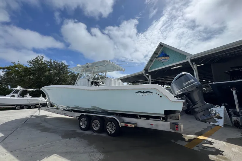 Slide: The Image of 2019 Invincible 39 Open Fisherman boat on trailer, parked outdoors under cloudy sky. - 15