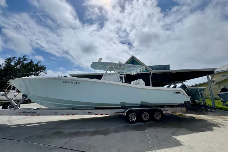 Slide: The Image of 2019 Invincible 39 Open Fisherman boat on trailer under cloudy sky. - 2
