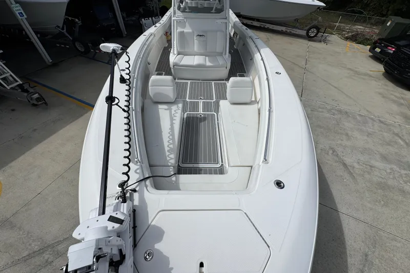 Slide: The Image of 2019 Invincible 39 Open Fisherman boat, spacious deck, white seating, docked outdoors. - 20