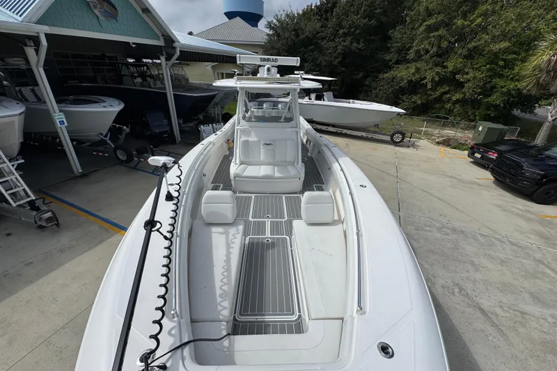 Slide: The Image of 2019 Invincible 39 Open Fisherman boat docked at marina, showcasing spacious deck. - 21