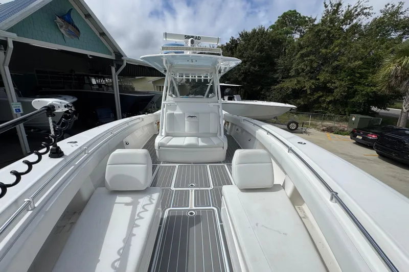 Slide: The Image of 2019 Invincible 39 Open Fisherman boat with spacious deck and seating, docked outdoors. - 22