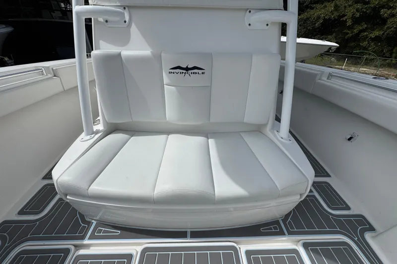 Slide: The Image of 2019 Invincible 39 Open Fisherman boat with white cushioned seating and logo. - 23