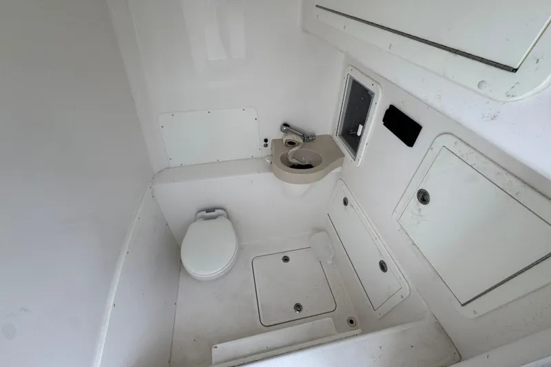 Slide: The Image of 2019 Invincible 39 Open Fisherman boat bathroom with toilet and sink. - 26