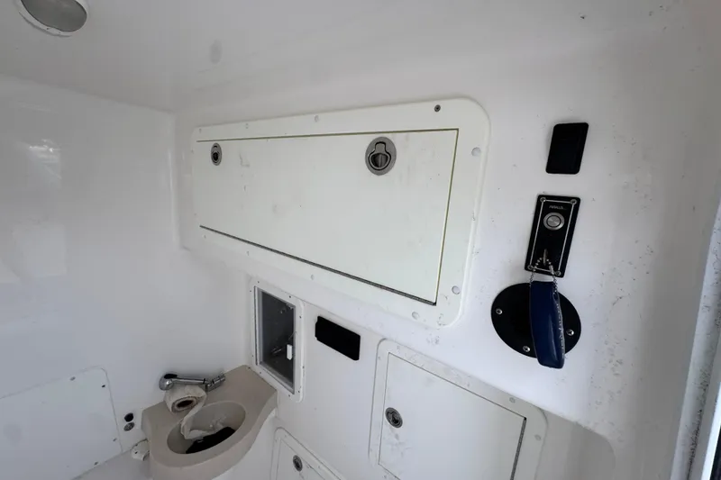 Slide: The Image of 2019 Invincible 39 Open Fisherman interior with storage compartments and control panel. - 28