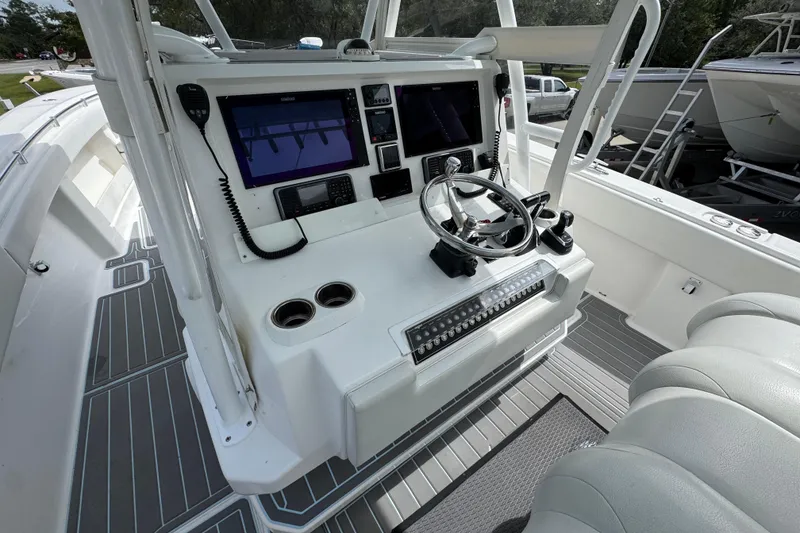 Slide: The Image of 2019 Invincible 39 Open Fisherman boat cockpit with modern controls and dual screens. - 32
