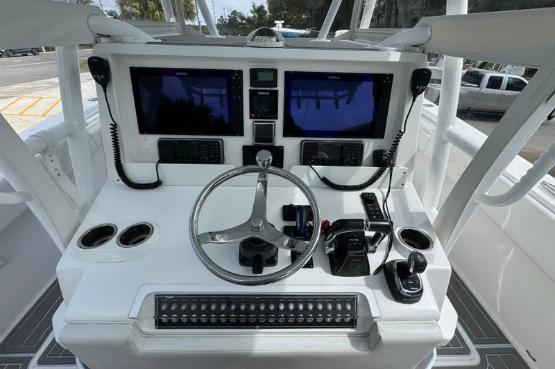 Slide: The Image of 2019 Invincible 39 Open Fisherman helm with dual displays and controls. - 33