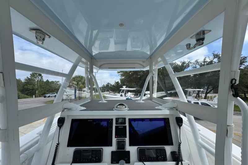 Slide: The Image of 2019 Invincible 39 Open Fisherman boat cockpit with navigation equipment and clear canopy. - 34