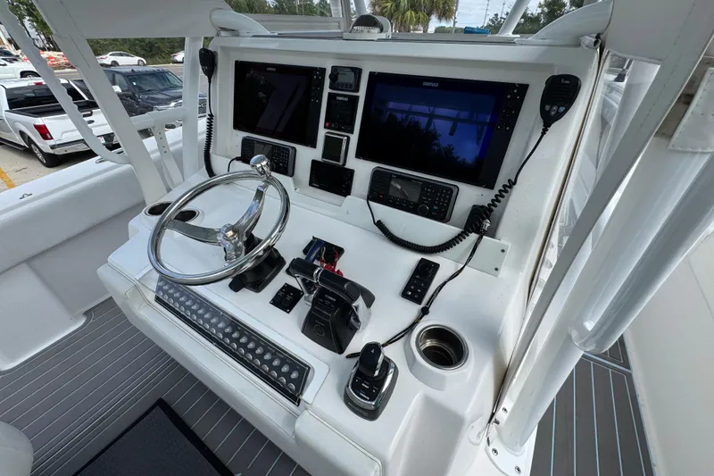 Slide: The Image of 2019 Invincible 39 Open Fisherman boat console with steering wheel and navigation screens. - 35