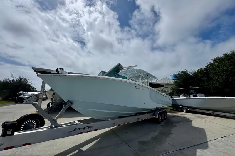 Slide: The Image of 2019 Invincible 39 Open Fisherman boat on trailer under cloudy sky. - 4