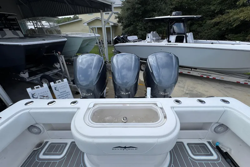 Slide: The Image of 2019 Invincible 39 Open Fisherman with triple 300 horsepower engines in a boatyard. - 42