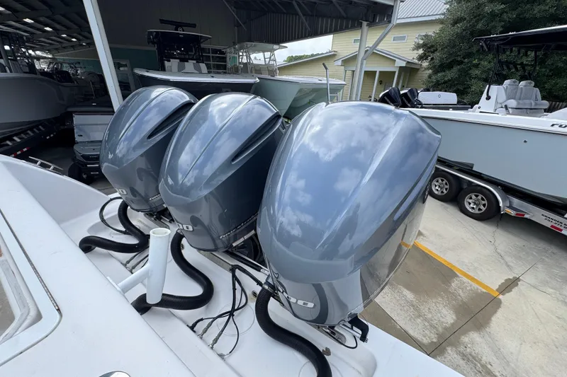 Slide: The Image of Triple outboard engines on a 2019 Invincible 39 Open Fisherman boat in a marina. - 43