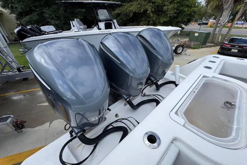 Slide: The Image of 2019 Invincible 39 Open Fisherman with triple Yamaha outboard engines, docked outdoors. - 44