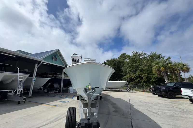 Slide: The Image of 2019 Invincible 39 Open Fisherman boat on trailer at marina under cloudy sky. - 6