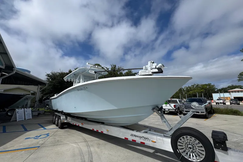 Slide: The Image of 2019 Invincible 39 Open Fisherman boat on trailer under cloudy sky. - 7