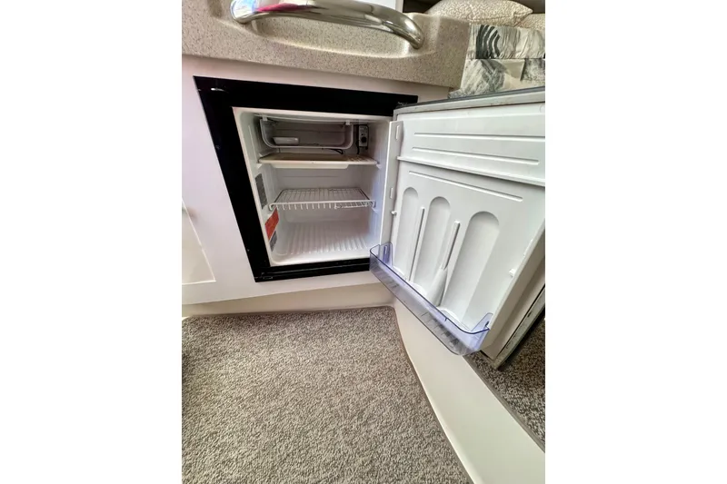 Slide: The Image of Open mini fridge inside 2001 Wellcraft 290 Coastal boat cabin. - 12
