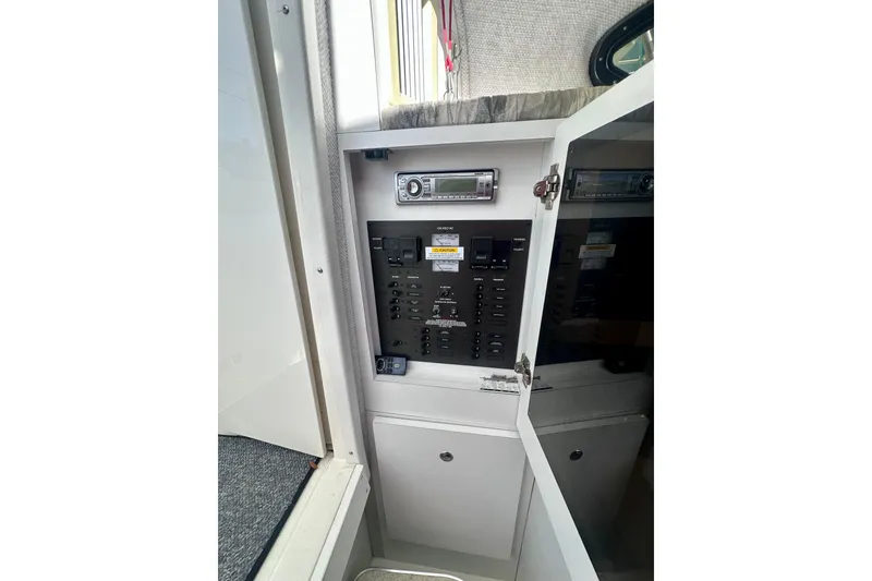 Slide: The Image of 2001 Wellcraft 290 Coastal boat interior control panel with stereo system. - 15