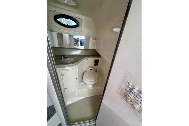 Slide: The Image of 2001 Wellcraft 290 Coastal boat bathroom with sink, toilet, and mirror. - 19