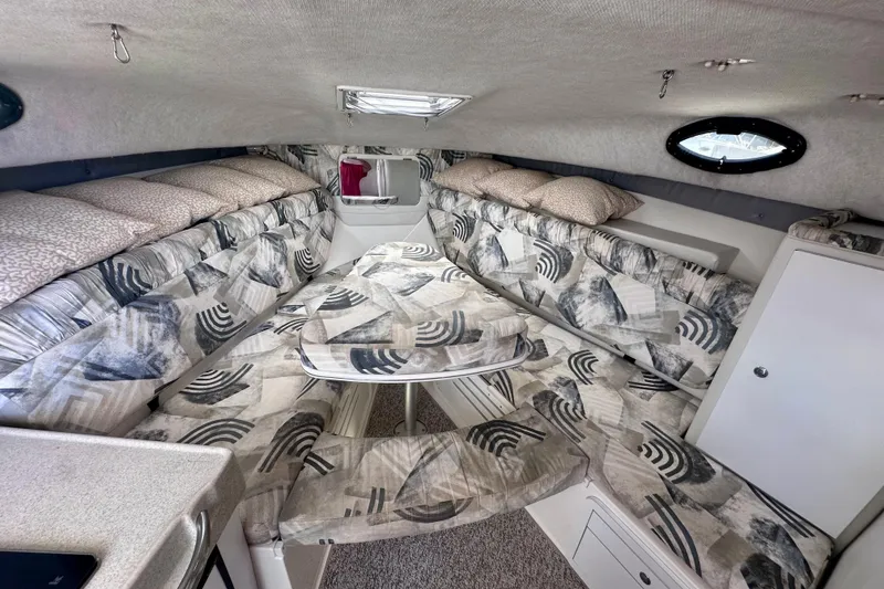 Slide: The Image of 2001 Wellcraft 290 Coastal cabin interior with patterned seating and compact design. - 24