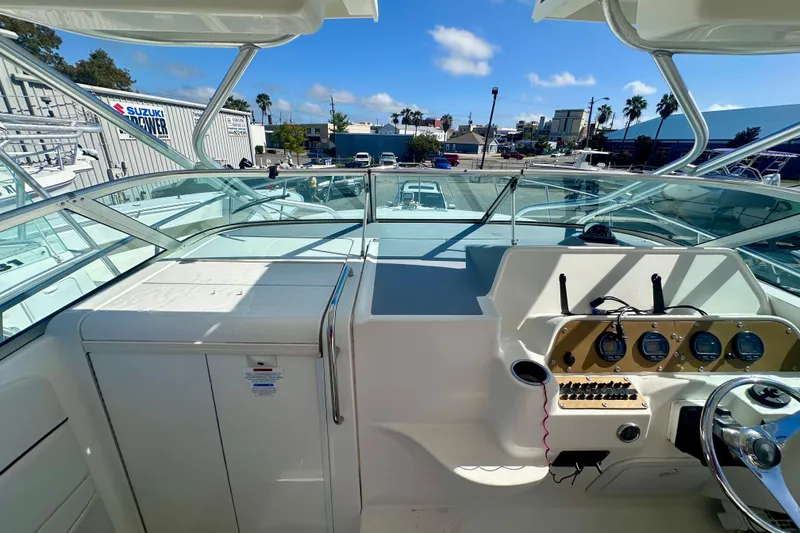 Slide: The Image of 2001 Wellcraft 290 Coastal boat cockpit with steering wheel and instrument panel, sunny day. - 25
